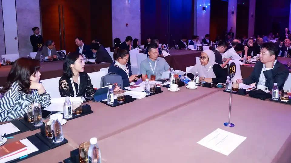 Delegates in small discussion groups around tables